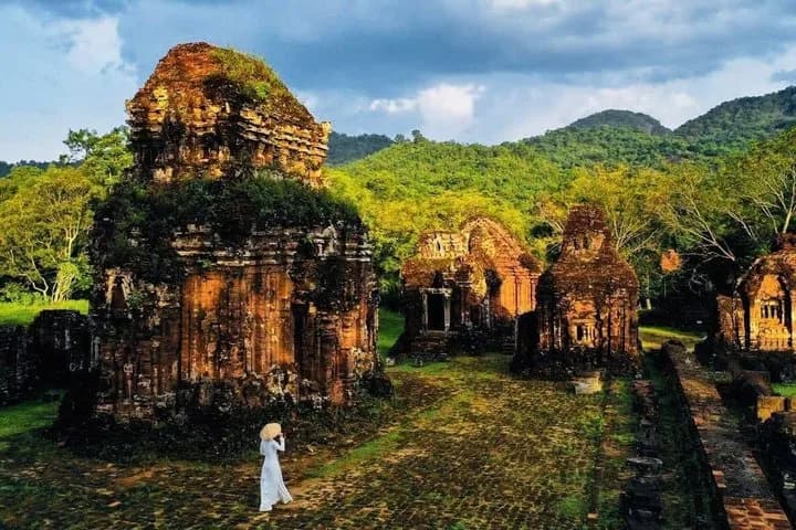 Couple walking along the path between temple groups at My Son Sanctuary on a private tour.
