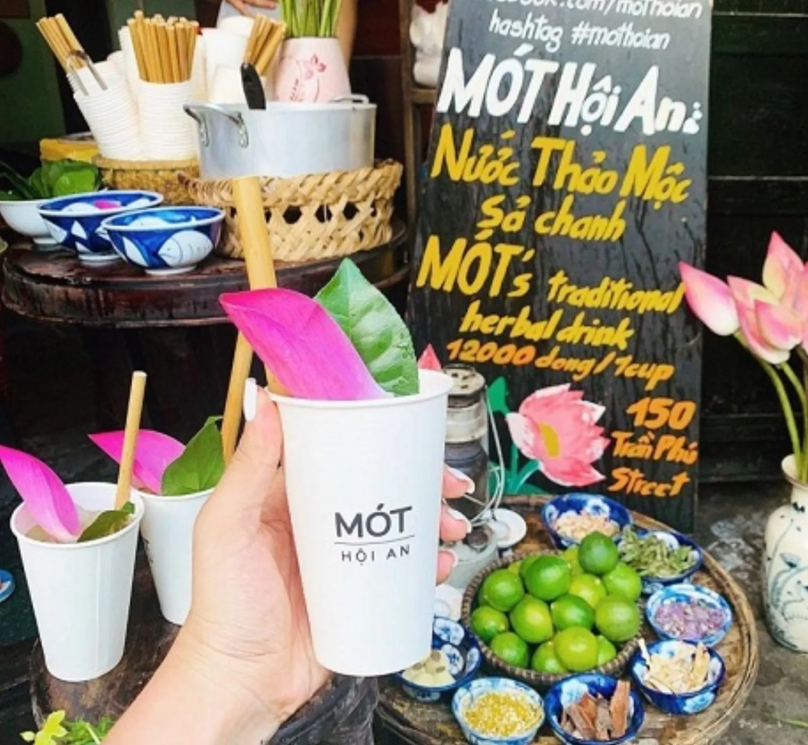 A cup of Mot, the traditional herbal drink of Hoi An Old Town, topped with a lotus petal.