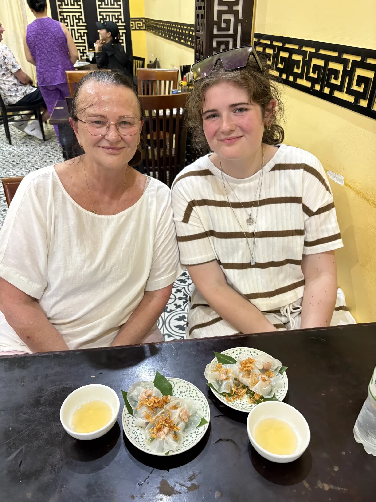 Travellers sharing a meal at the White Rose restaurant in Hoi An, a regular stop on the private food tour.