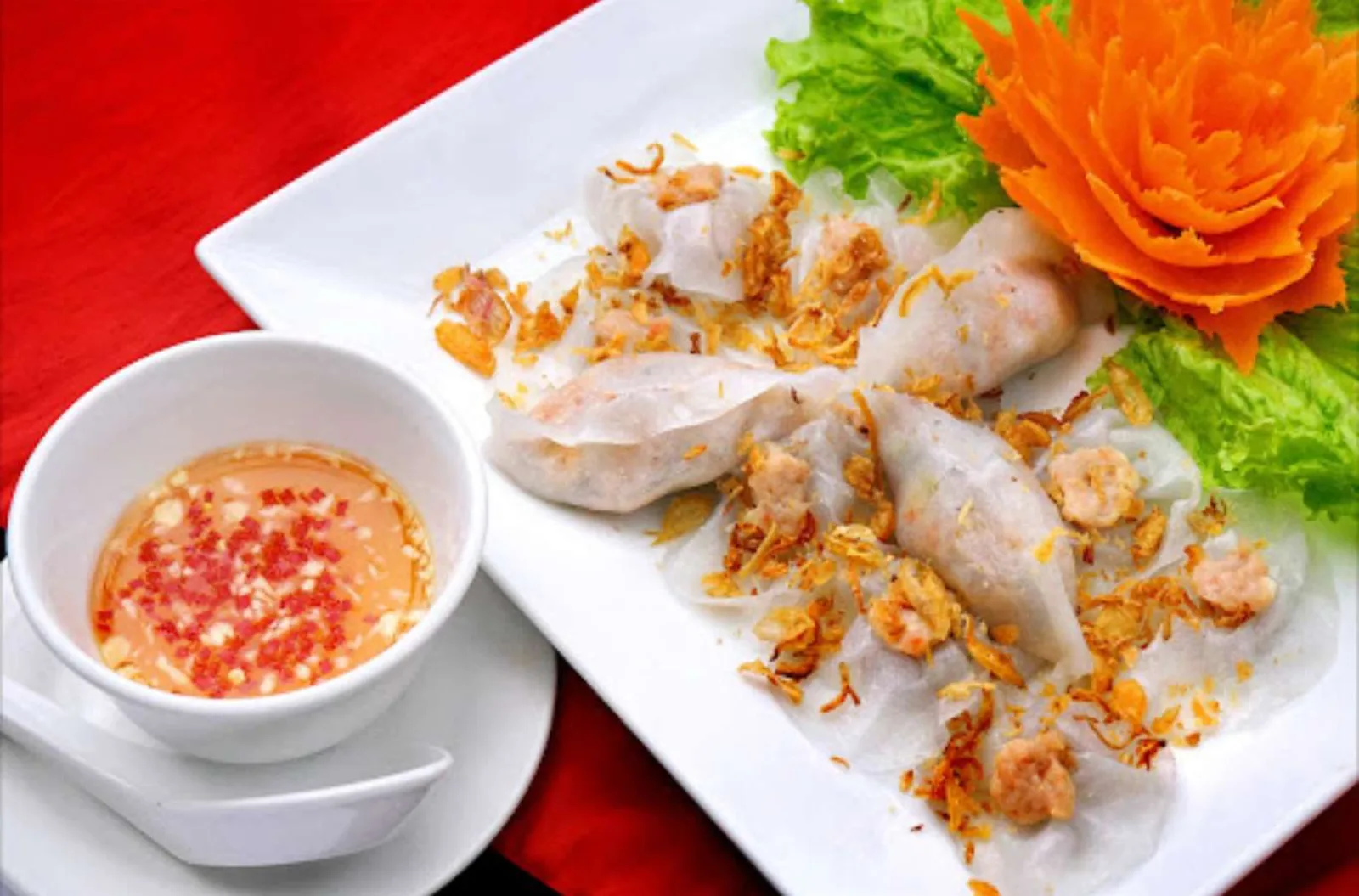 White rose dumplings — banh bao banh vac — served with the shop's signature dipping sauce.