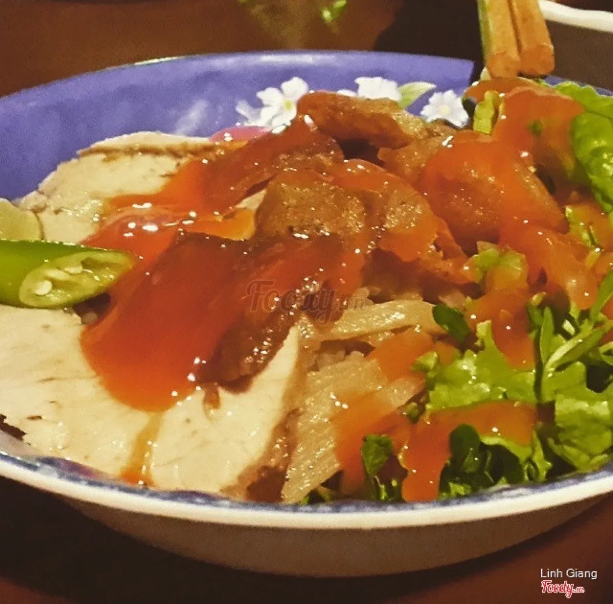 Cao lầu served with fresh herbs and greens