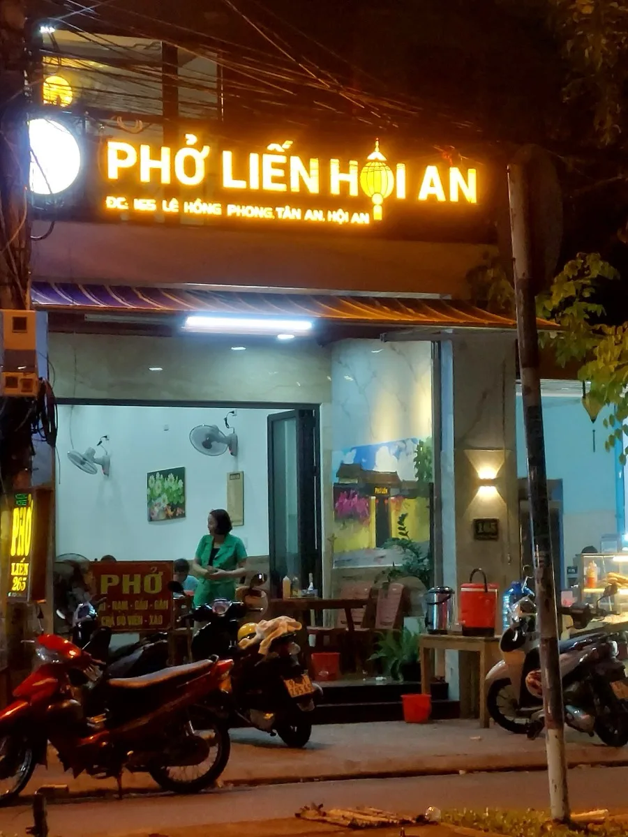 Phở Liến at its current home, 165 Lê Hồng Phong, at night with the lantern-shaped logo lit up