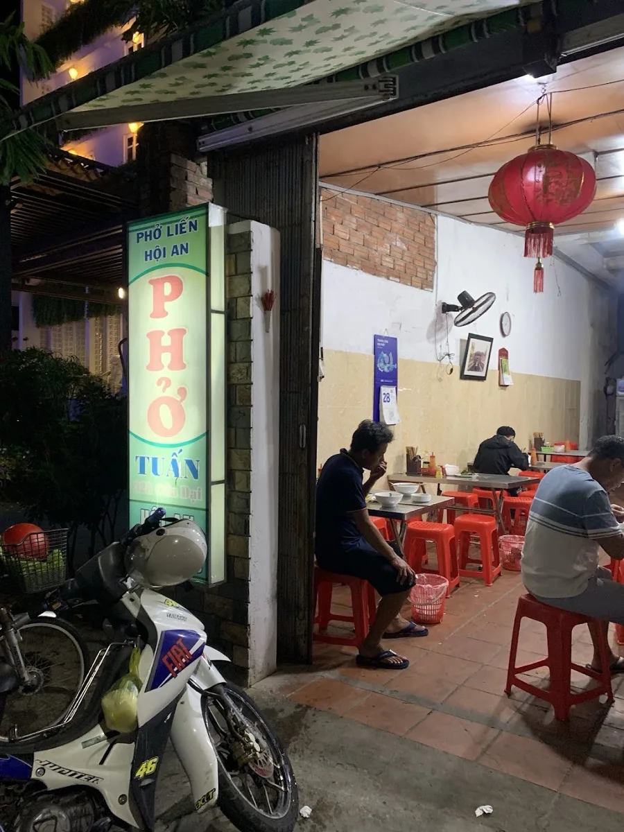 Phở Tuấn's lit sign at night on Cửa Đại street