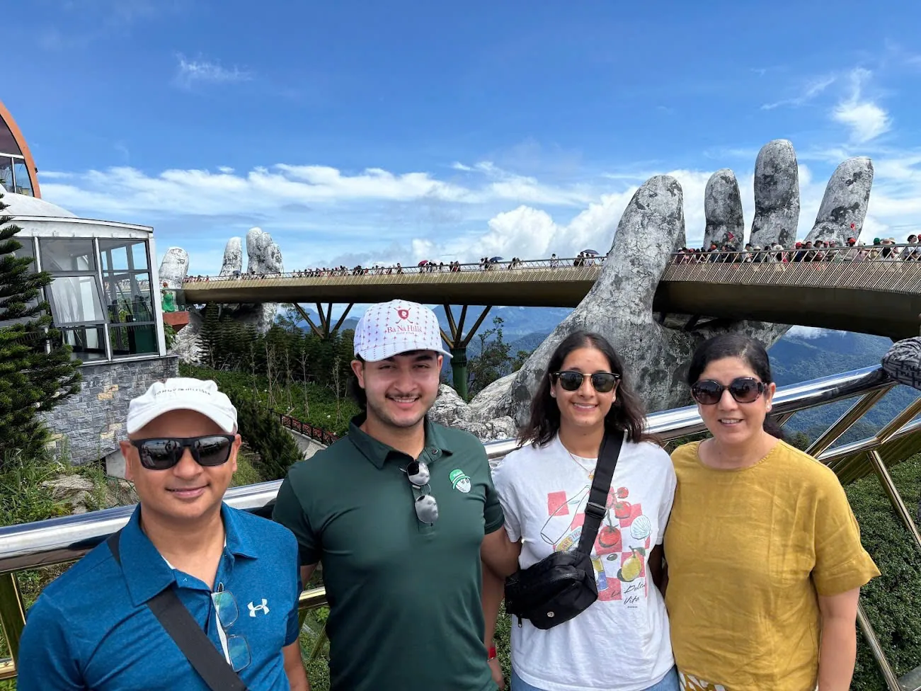 Four guests in front of the Golden Bridge at Ba Na Hills, a common stop on the Da Nang side.