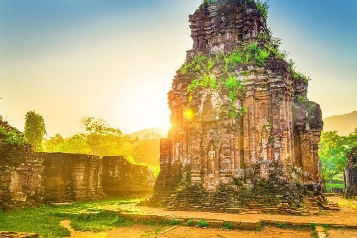 Sunrise light behind a Cham brick tower at My Son Sanctuary.