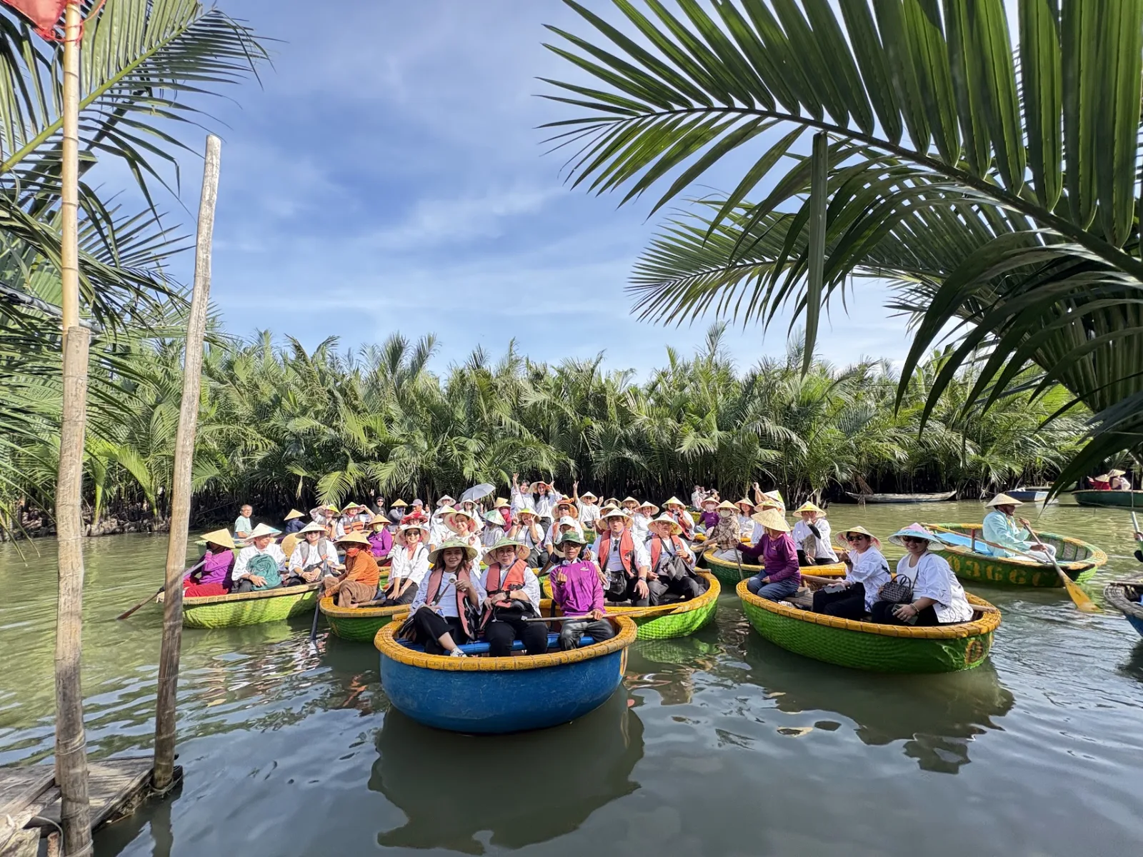 Guests riding basket boats through the Bay Mau coconut forest near Hoi An.