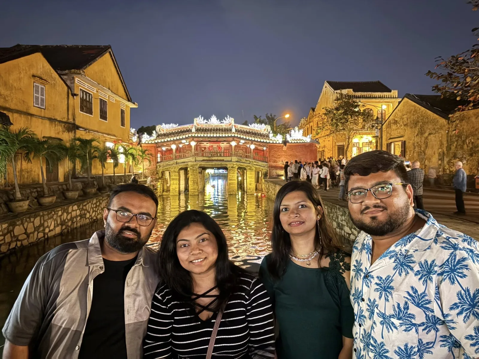 Guests photographed at the Japanese Covered Bridge at dusk.