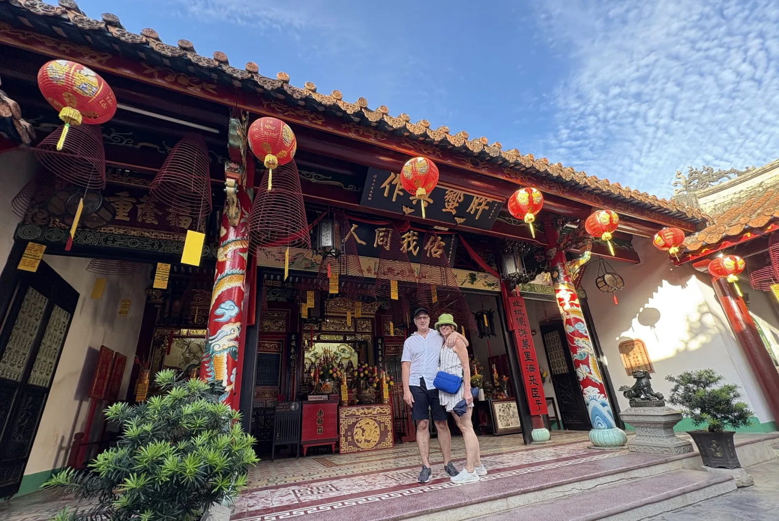 Two travellers visiting one of the Chinese assembly halls of Hoi An Ancient Town.