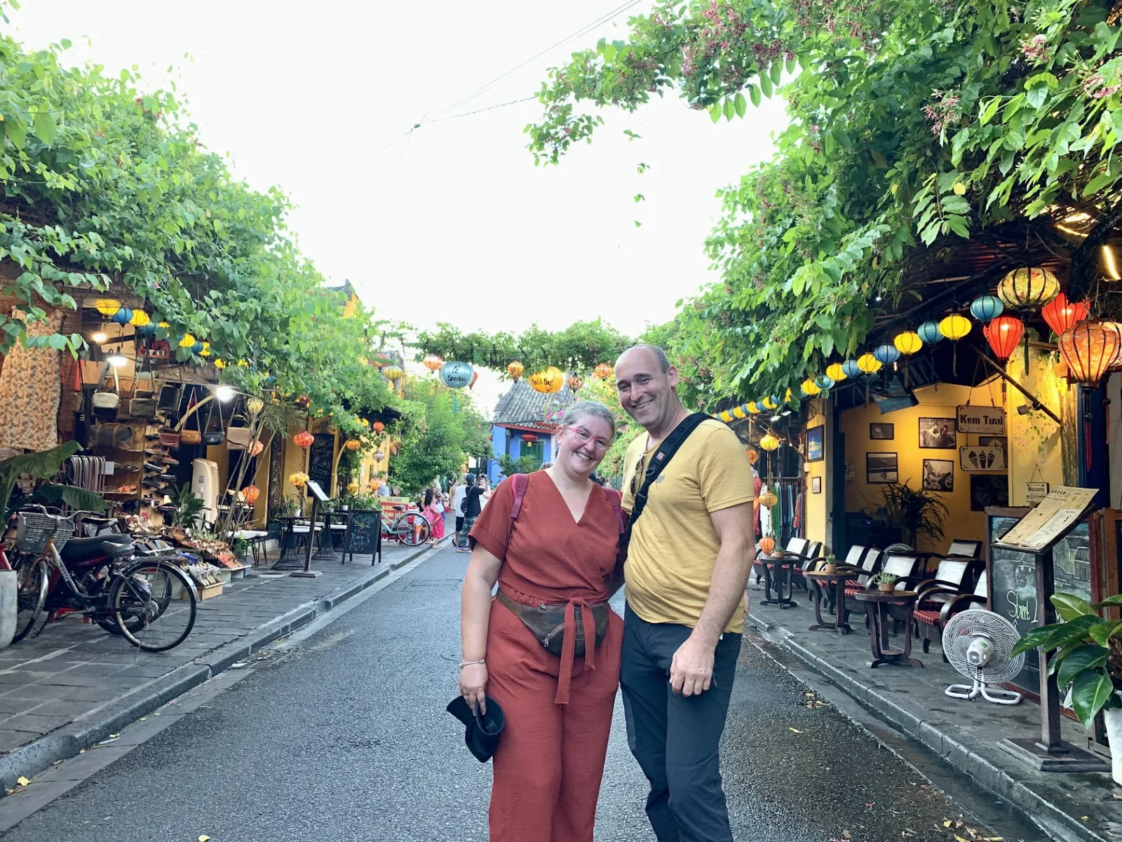 A couple on a lantern-strung street in Hoi An Ancient Town at night.