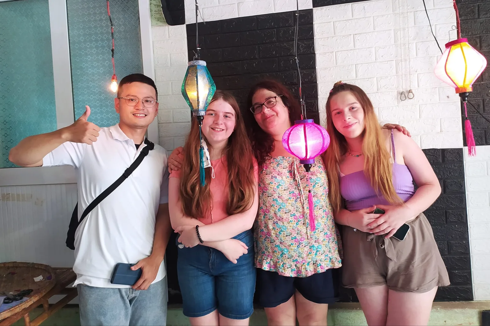 Fin with three guests at the Hoi An lantern-making class where travellers build their own lantern.